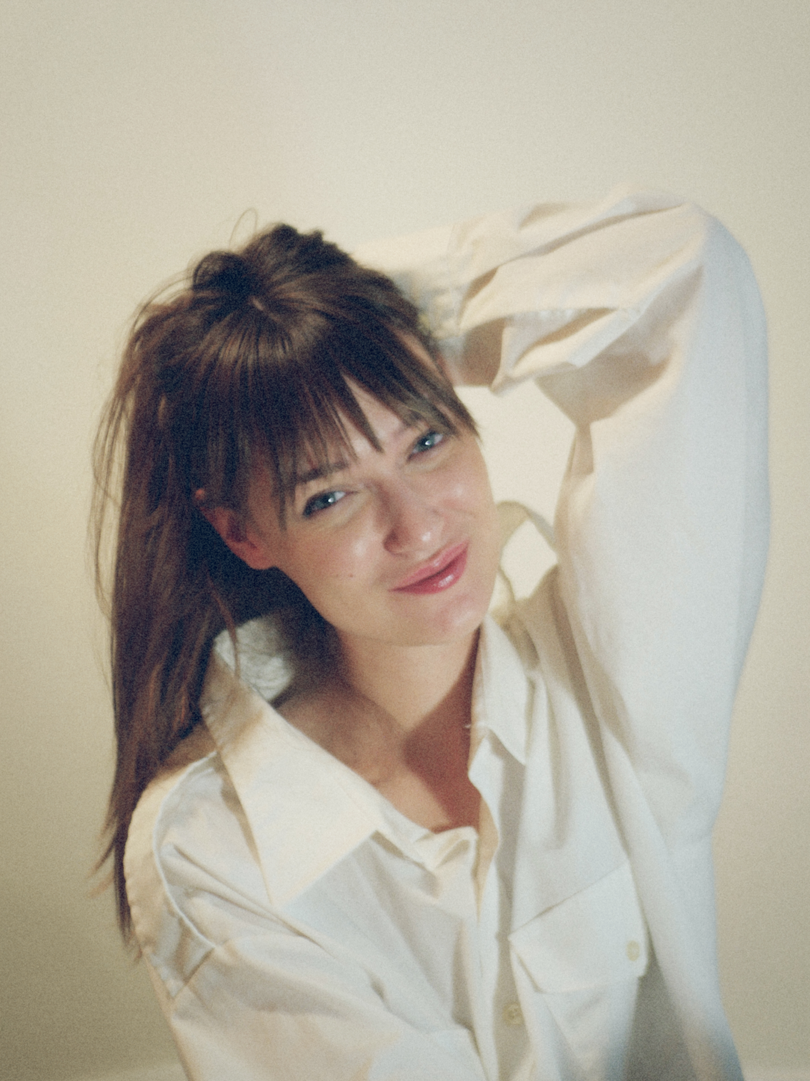 Kris Brouillette, Brand Strategist, Orlé, smiling with one hand behind her head
